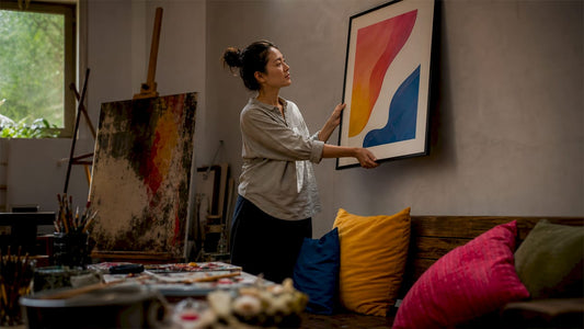 Woman matching art with living room decor