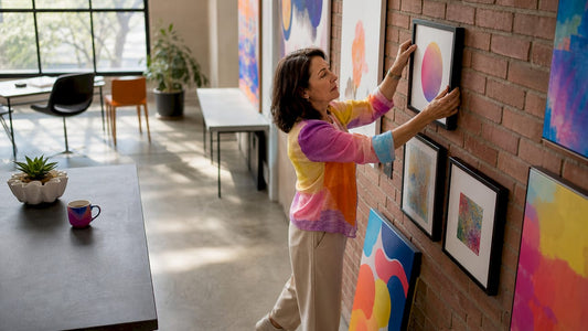 Woman installing customer art in café